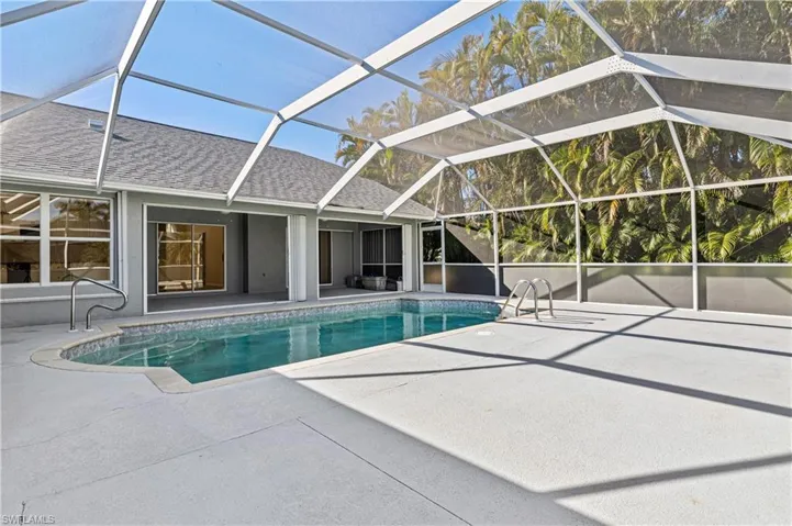 Outdoor pool with large lanai and pool cage
