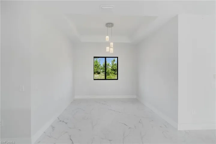Tiled empty room with a raised ceiling