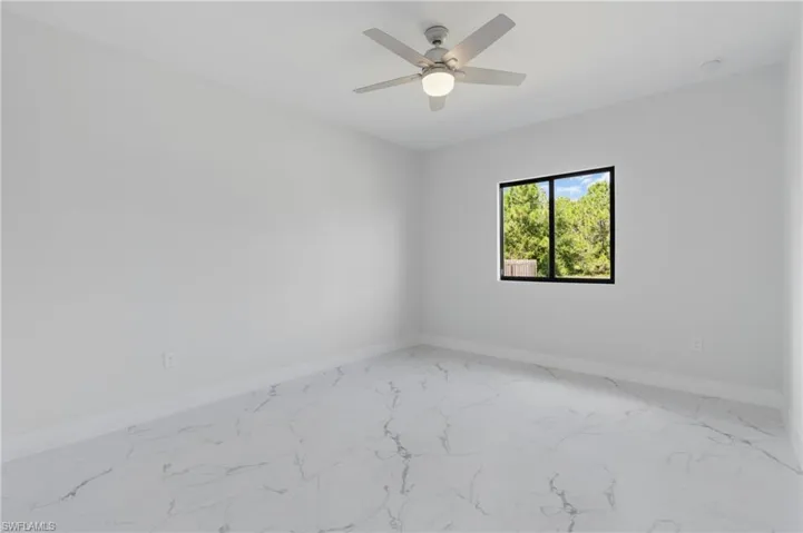 Empty room featuring ceiling fan