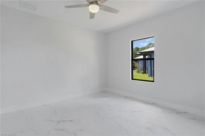 Empty room featuring ceiling fan