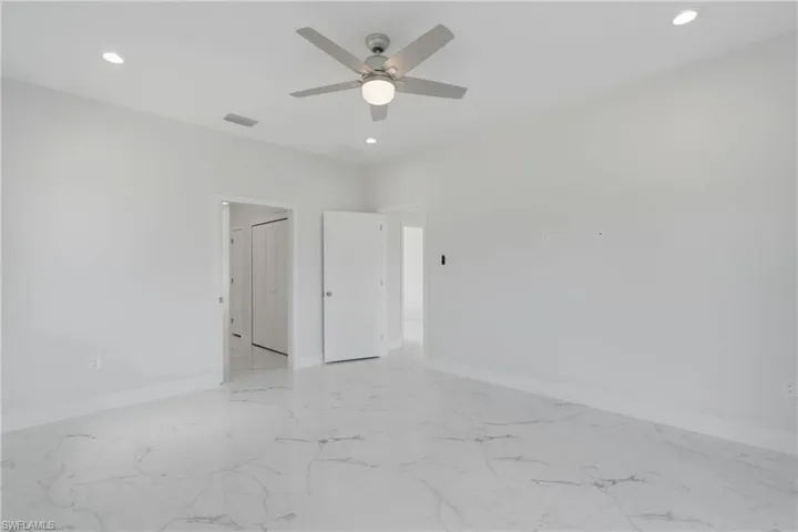 Spare room with light tile patterned flooring and ceiling fan
