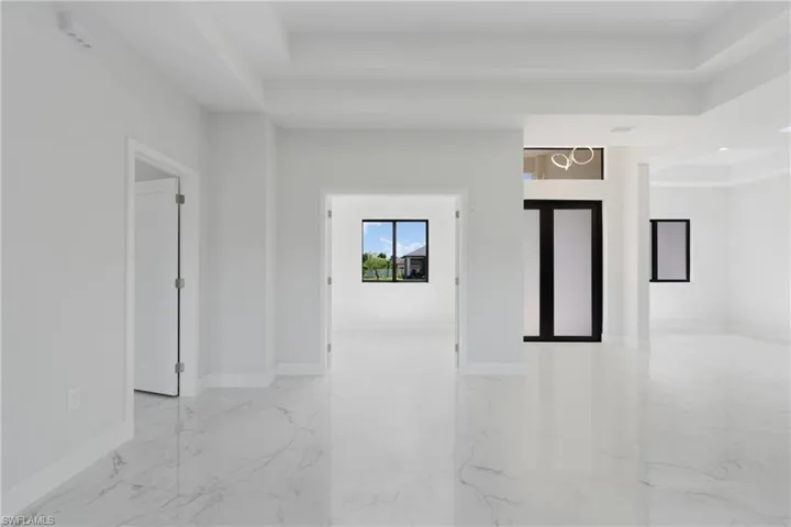 Unfurnished room with light tile patterned floors and a raised ceiling