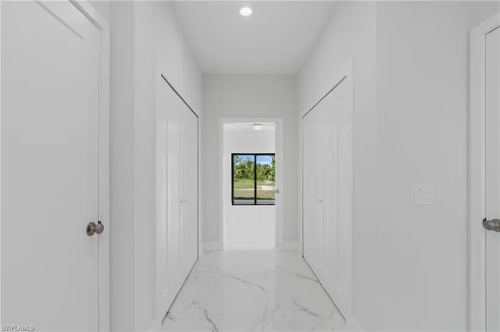 Hallway with light tile patterned floors