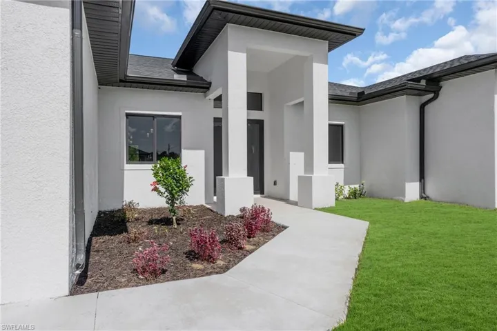 Entrance to property with a lawn