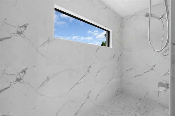 Bathroom featuring tiled shower