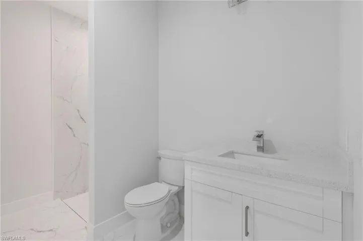 Bathroom with tile patterned floors, toilet, and vanity