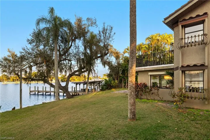 View of yard with a boat dock and a water view