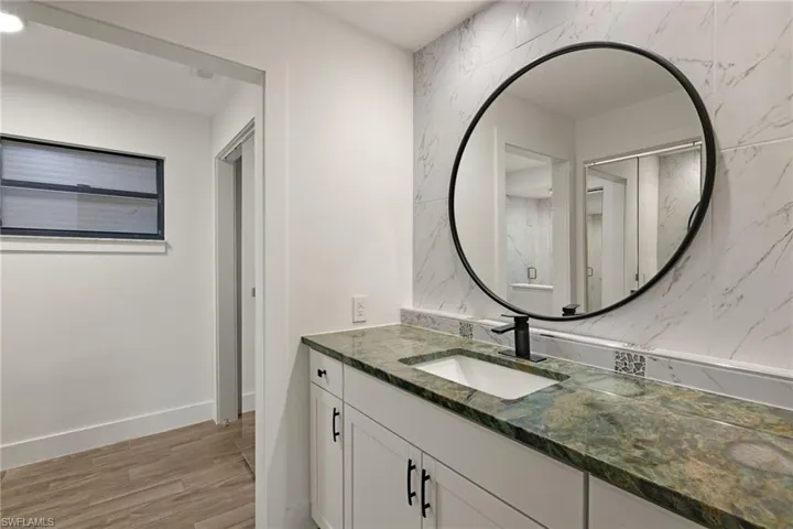 Bathroom featuring vanity and hardwood / wood-style floors