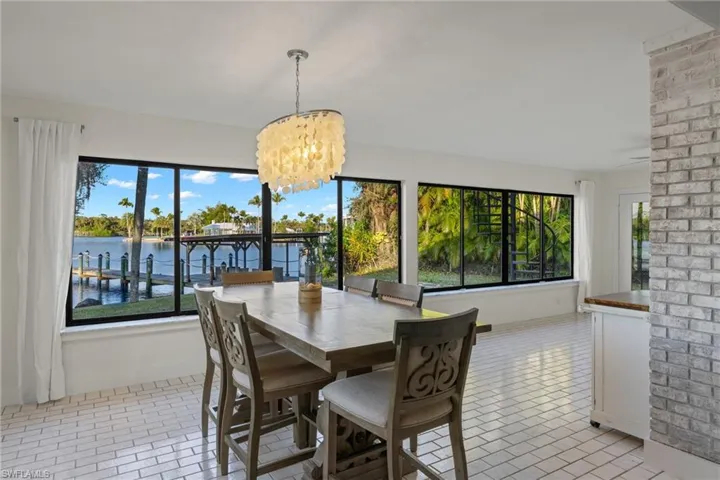 Unfurnished sunroom featuring a chandelier and a water view