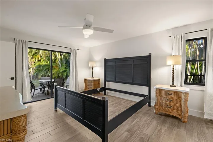 Bedroom with multiple windows, light hardwood / wood-style flooring, and access to outside