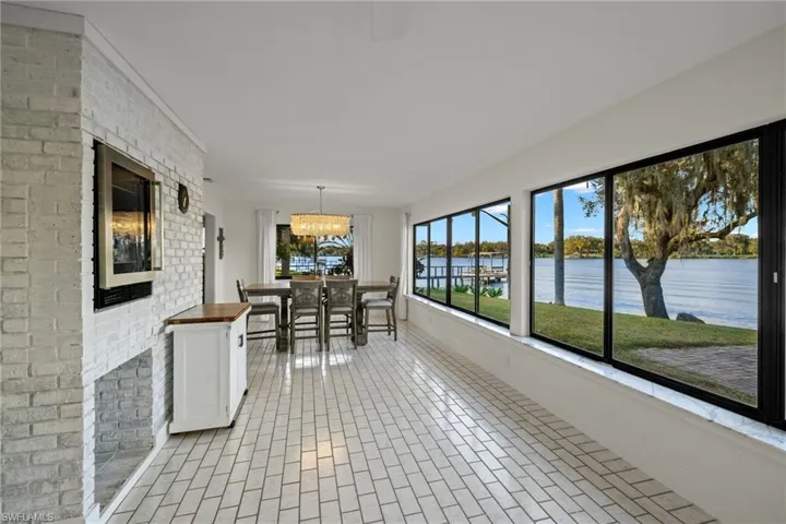 Unfurnished sunroom featuring a chandelier and a water view