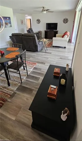 Living room with ceiling fan and wood finished floors