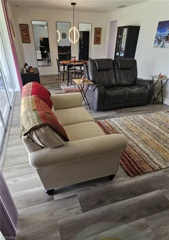 Living area with baseboards and wood finished floors