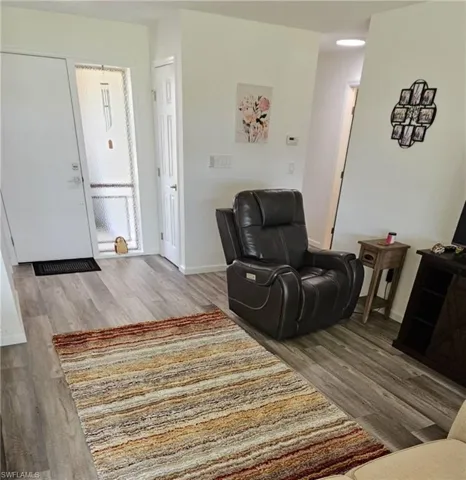 Sitting room with baseboards and wood finished floors