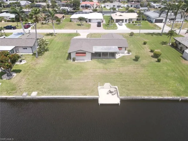 Drone / aerial view with a water view and a residential view