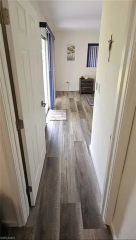 Hallway featuring wood finished floors