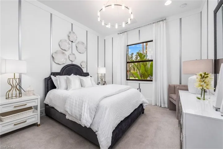 Bedroom featuring light colored carpet