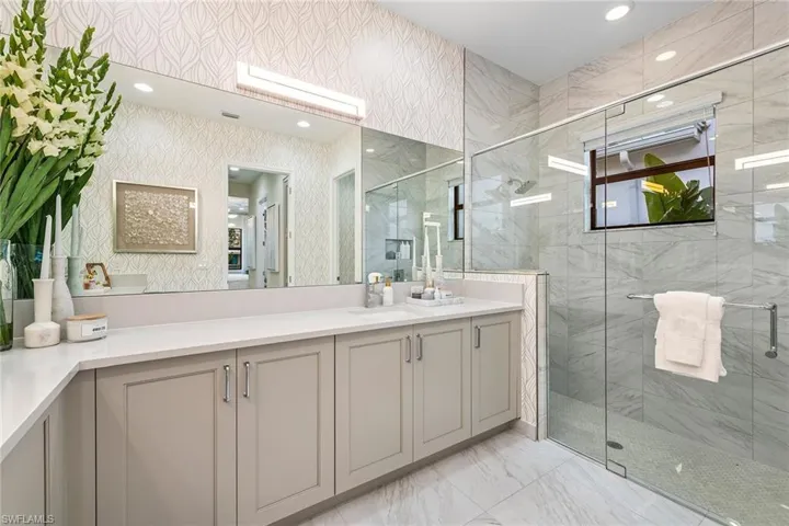 Bathroom featuring recessed lighting, vanity, marble finish floor, a stall shower, and wallpapered walls