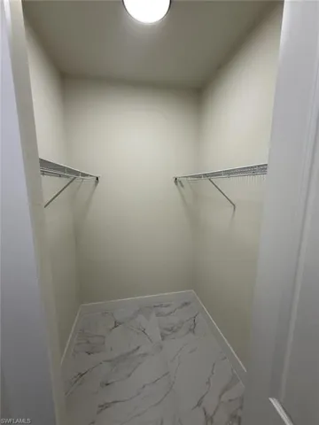 Spacious closet with marble finish flooring