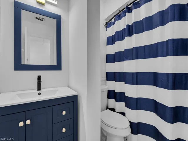 Bathroom featuring vanity and curtained shower