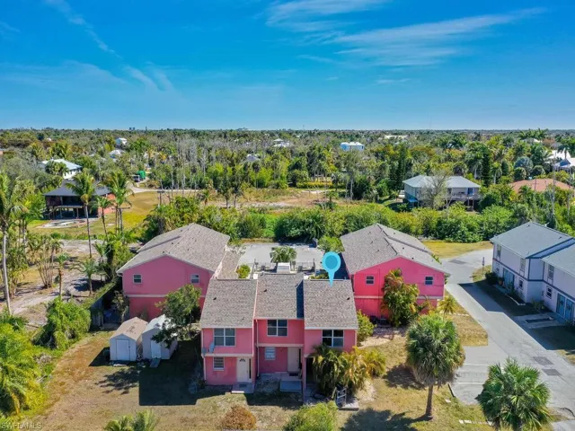 Aerial view of residential area featuring a tree filled landscape