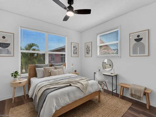 Bedroom featuring ceiling fan, dark wood-style flooring, and a textured ceiling