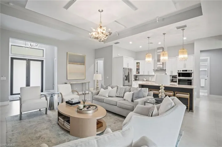 Living room featuring a chandelier, recessed lighting, and light tile patterned floors