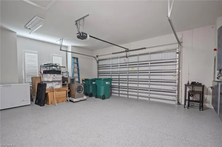 Garage with refrigerator and a garage door opener