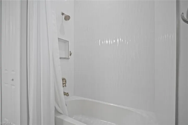 Full bathroom featuring shower / bath combo with shower curtain