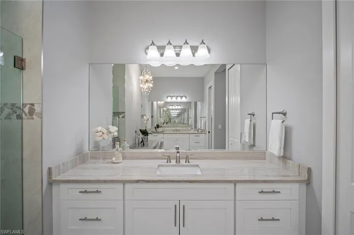 Bathroom featuring vanity and a stall shower