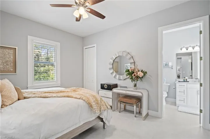 Bedroom featuring a closet, connected bathroom, and ceiling fan