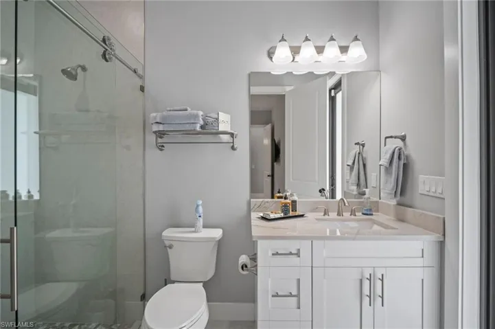 Bathroom featuring vanity and a shower stall