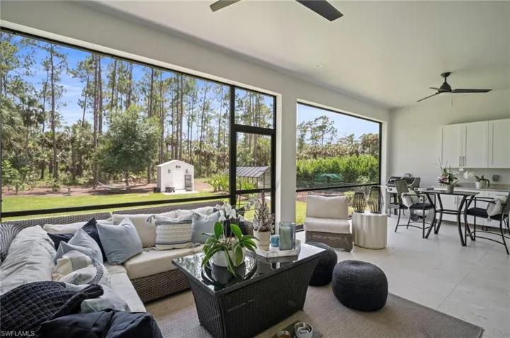 Sunroom with ceiling fan, an outdoor hangout area, and outdoor dining space