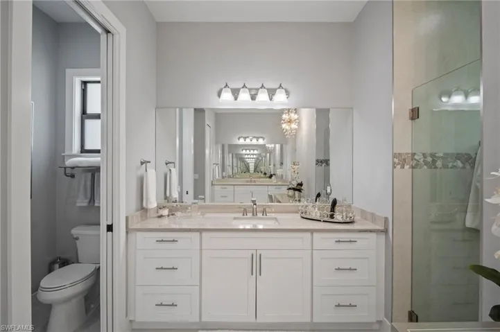 Bathroom with a shower stall and vanity