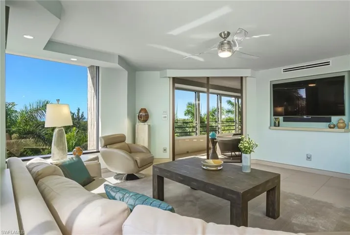Living area with a ceiling fan, recessed lighting, and tile patterned floors