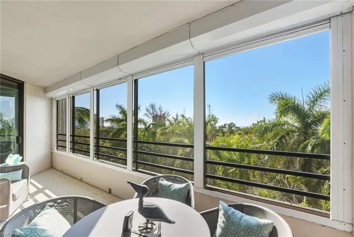 Sunroom / solarium featuring outdoor dining area and a balcony