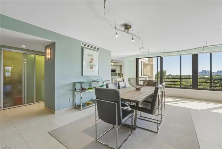 Dining area with tile patterned flooring and ceiling fan
