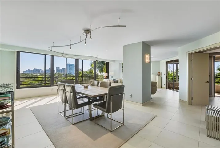 Dining room featuring a skyline view and light tile patterned flooring