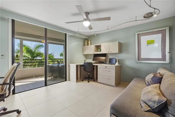 Office area featuring ceiling fan, built in desk, and light tile patterned floors