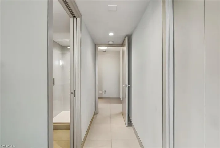 Hallway with recessed lighting and light tile patterned floors
