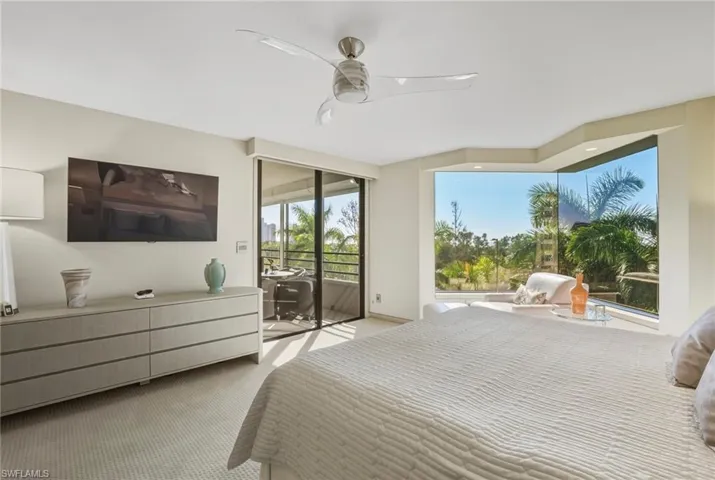 Bedroom featuring carpet flooring, access to exterior, and a ceiling fan