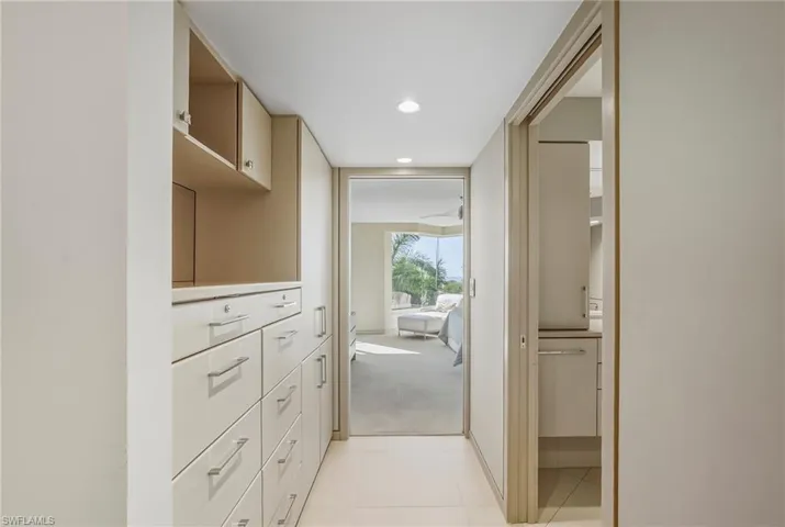 Corridor with light colored carpet, recessed lighting, and light tile patterned floors