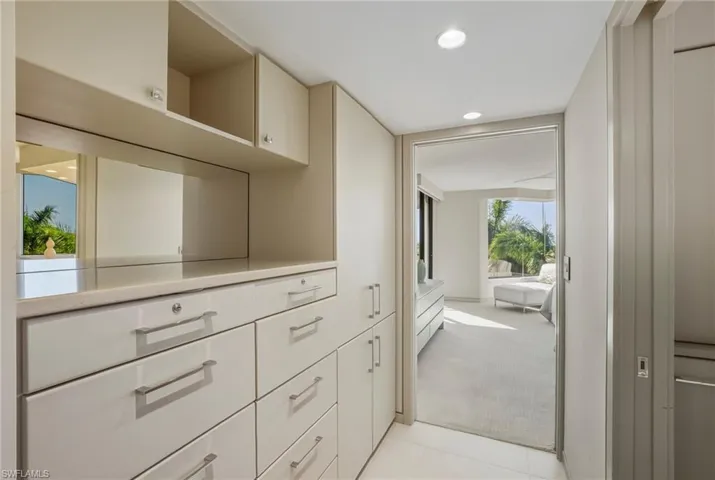 Corridor featuring recessed lighting and light colored carpet