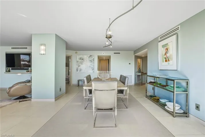Dining area with rail lighting and baseboards