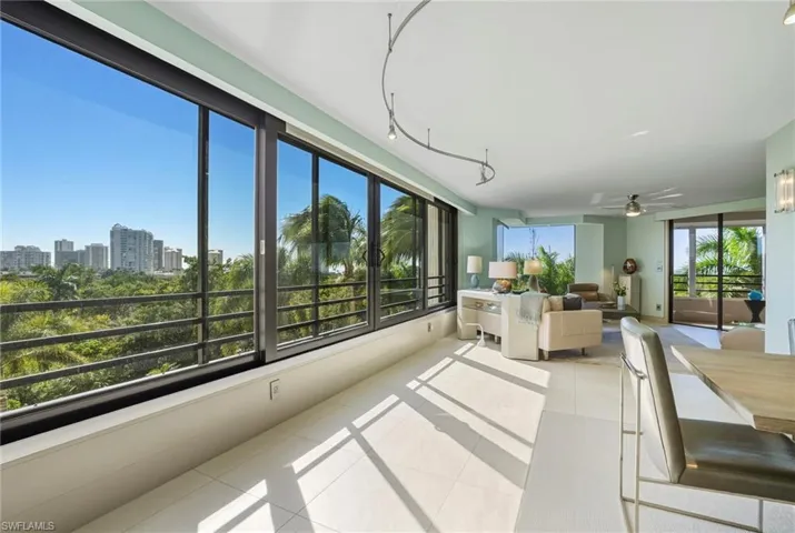 Sunroom featuring tile patterned floors and a skyline view