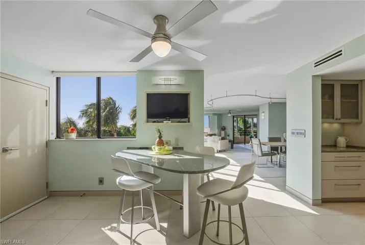 Dining room with a ceiling fan and light tile patterned flooring
