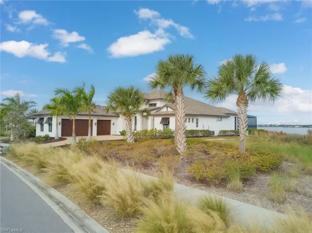 Ranch-style home featuring an attached garage, stucco siding, and driveway