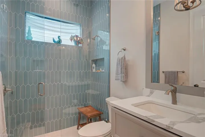 Bathroom with a stall shower and vanity