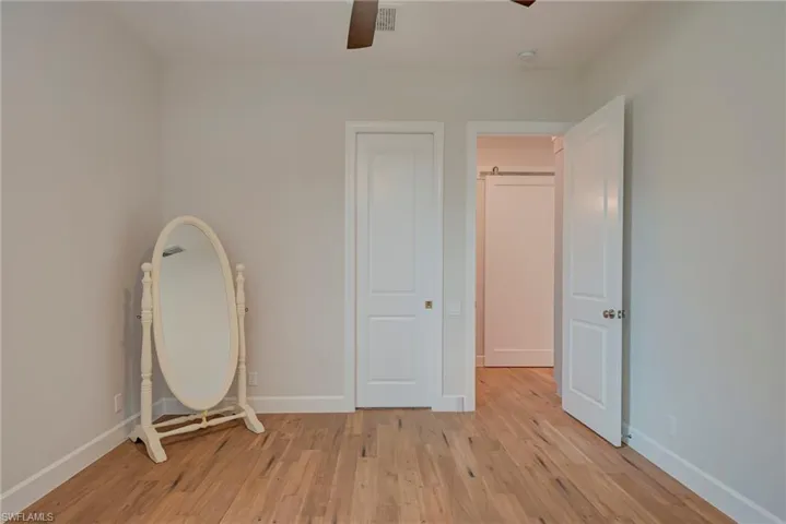 Unfurnished bedroom featuring light wood-style floors and a ceiling fan