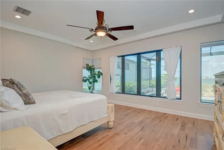 Bedroom with light wood finished floors, recessed lighting, and ceiling fan